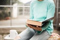 Young female asian girl sitting opened page of the book for read
