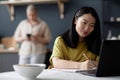 Asian Girl Making Notes in Notebook Royalty Free Stock Photo