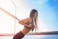 Young female athlete  doing morning  exercises  training  with trx fitness straps in the park. Concept of healthy workout and Royalty Free Stock Photo