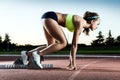 Young female athlete launching off the start line in a race. Royalty Free Stock Photo