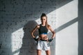A young female athlete with a perfect body and abs is preparing for training in the early morning Royalty Free Stock Photo
