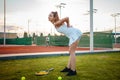 A young female athlete was injured. Tennis court, sunset. The girl suffers from pain, stretching, ligament damage Royalty Free Stock Photo