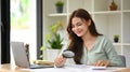 Young female auditor inspecting financial document with a magnifying glass at office desk Royalty Free Stock Photo