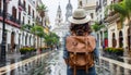 Young female backpacker exploring streets of historic spanish town on solo travel adventure