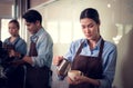 Young female barista adept in champion coffee brewing, creating latte art in a cup of coffee