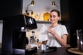 Young female barista thoughtfully wipes the counter at the workplace in a restaurant where milk was spilled