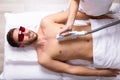 Beautician Giving Laser Epilation Treatment On Man`s Chest Royalty Free Stock Photo