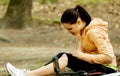 Young female bicyclist with hurt leg Royalty Free Stock Photo