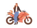 Young female biker posing near motor bike. Woman standing by modern motorcycle. Happy motorcyclist and motorbike Royalty Free Stock Photo