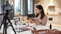 Wake up and Make up. Young female blogger applying makeup, testing cosmetic products while recording a tutorial video Royalty Free Stock Photo