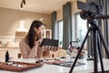 All for being a girl. Young female blogger applying makeup, testing cosmetic products while recording a tutorial video Royalty Free Stock Photo