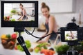 Young female blogger vlogger and online influencer recording video content on healthy food Royalty Free Stock Photo