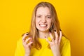 Young female with blond hair in yellow T-shirt. Negative human emotions, face expressions. Film effect Royalty Free Stock Photo