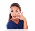 Young female in blue blouse gesturing a call Royalty Free Stock Photo