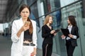 Young female boss reads messages on android. The concept of the Internet, technology, business, communication Royalty Free Stock Photo