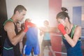 Young female boxer practicing punch with male Royalty Free Stock Photo