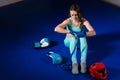 Young female boxer preparing bandages for fight near lying boxing gloves and helmet Royalty Free Stock Photo