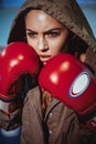 Young female boxer ready to fight in leather boxing gloves. fitness blonde girl in sport wear with perfect body Royalty Free Stock Photo