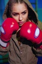 Young female boxer ready to fight in old leather boxing gloves. fitness happy blonde girl in sport wear with perfect body Royalty Free Stock Photo