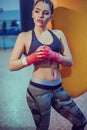 Young female boxer workout in gym. fitness blonde girl in sport wear with perfect body in the boxing gym posing