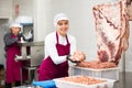 Young female butcher preparing minced meat for sale Royalty Free Stock Photo
