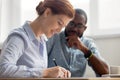 Young female candidate signing contract after successful interview in office Royalty Free Stock Photo