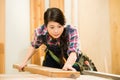 Young female carpenter cutting wood Royalty Free Stock Photo