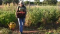 Young female carrying a basket with vegetables