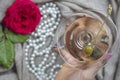Young female caucasian hand holding a martini with olives, closeup, top view Royalty Free Stock Photo
