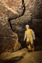 Young female caver exploring the cave Royalty Free Stock Photo