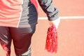 Young female cheerleaders holding pom-poms during competitions