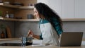 Young female chef arabian spanish woman watching online tutorial culinary video use internet food recipe helpful cookery