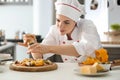 Young female chef cooking tasty pizza in kitchen Royalty Free Stock Photo