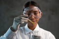 Young female chemist doing science experiment with chemicals