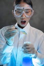 Young female chemist doing science experiment with chemicals Royalty Free Stock Photo