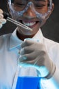 Young female chemist doing science experiment with chemicals Royalty Free Stock Photo