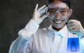 Young female chemist doing science experiment with chemicals