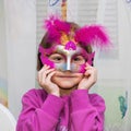 Young female child with red Mardi Gras mask Royalty Free Stock Photo