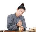 A young female Chinese medicine doctor mashed the herbs using a medicine mortar Royalty Free Stock Photo