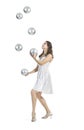 A young female circus performer, juggles silver balls. Royalty Free Stock Photo