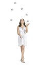 A young female circus performer, juggles silver balls. Royalty Free Stock Photo