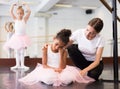 Ballet teacher comforting tired little ballerina Royalty Free Stock Photo