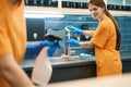 Young female cleaners clean and disinfect surfaces in kitchen area Royalty Free Stock Photo