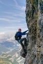 Young female climber on a vertical and exposed rock wall