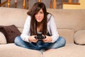 Young female concentrating playing videogames