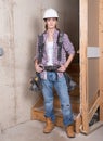 Young female contractor with carpenter equipment