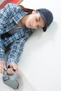 Young female craftsman fitting carpet on floor Royalty Free Stock Photo