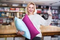 Young female customer boasting purchased home textiles