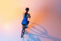 Cyclist riding a bicycle isolated against neon background. Top view Royalty Free Stock Photo