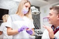 Young female dental technician consulting with a mature male doctor in dental clinic Royalty Free Stock Photo